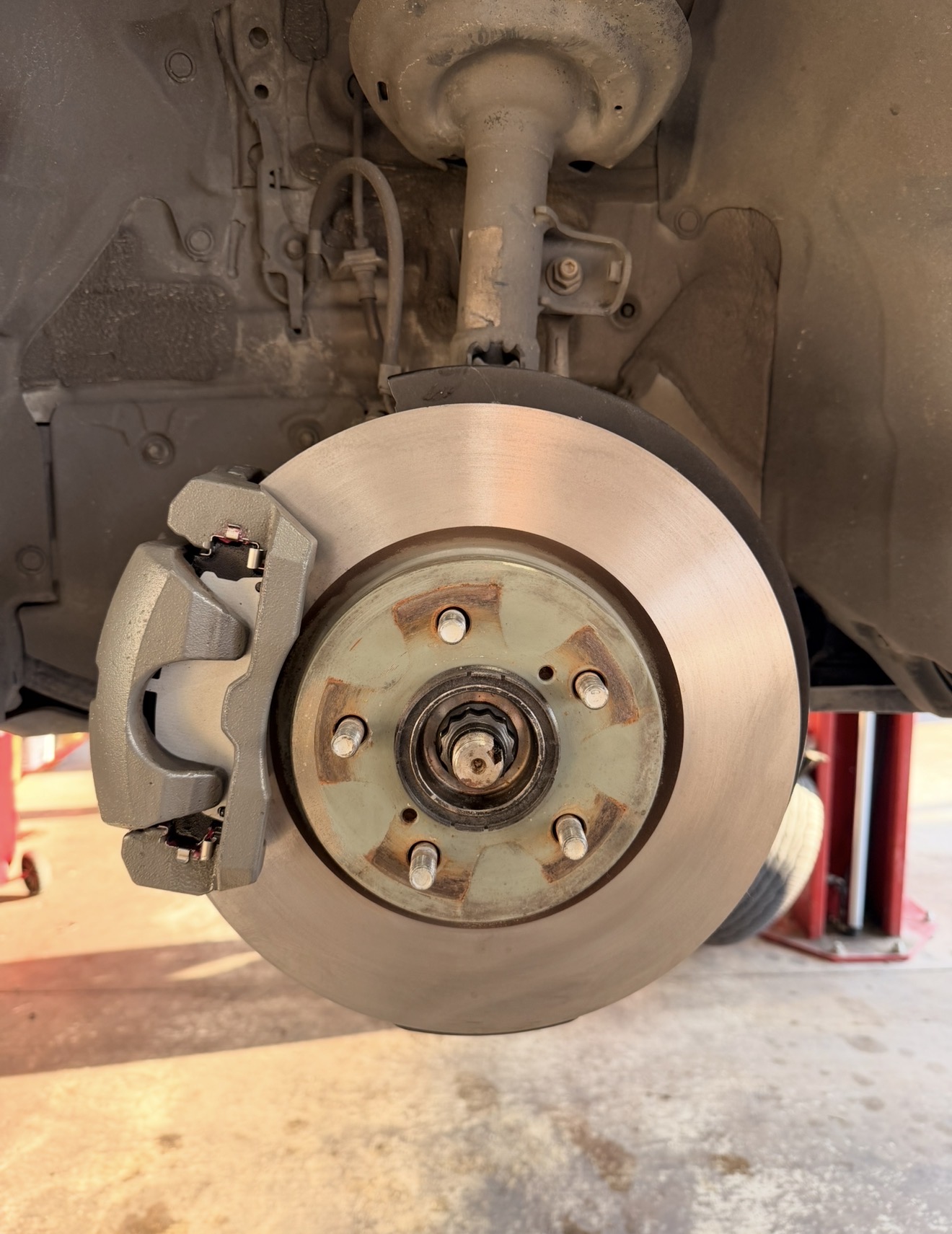 Toyota Camry front brake rotor and caliper after service